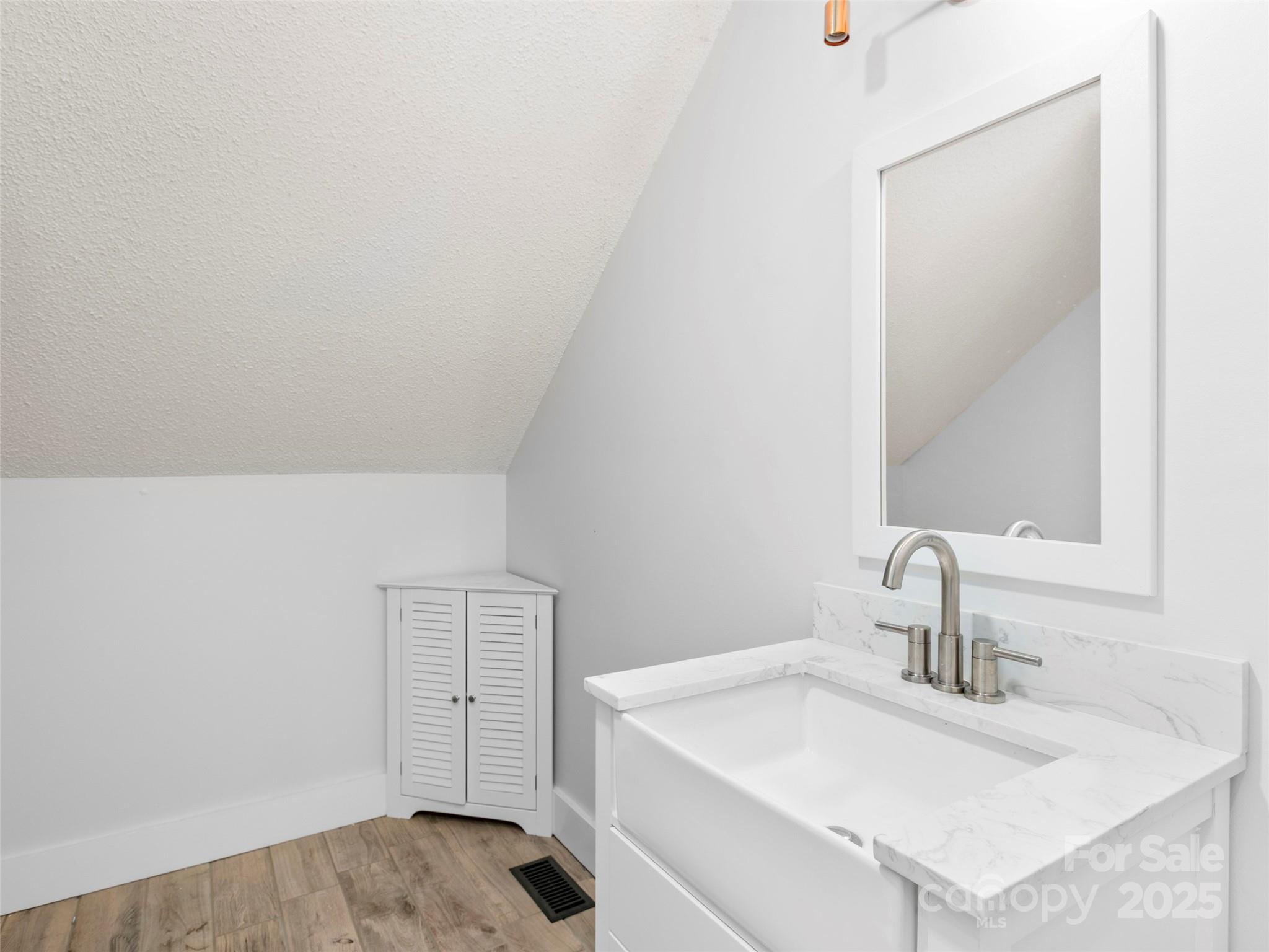 373 Vineyard Road Tryon, NC 28782 - Photo 25 of 46 a bathroom with a sink and a mirror