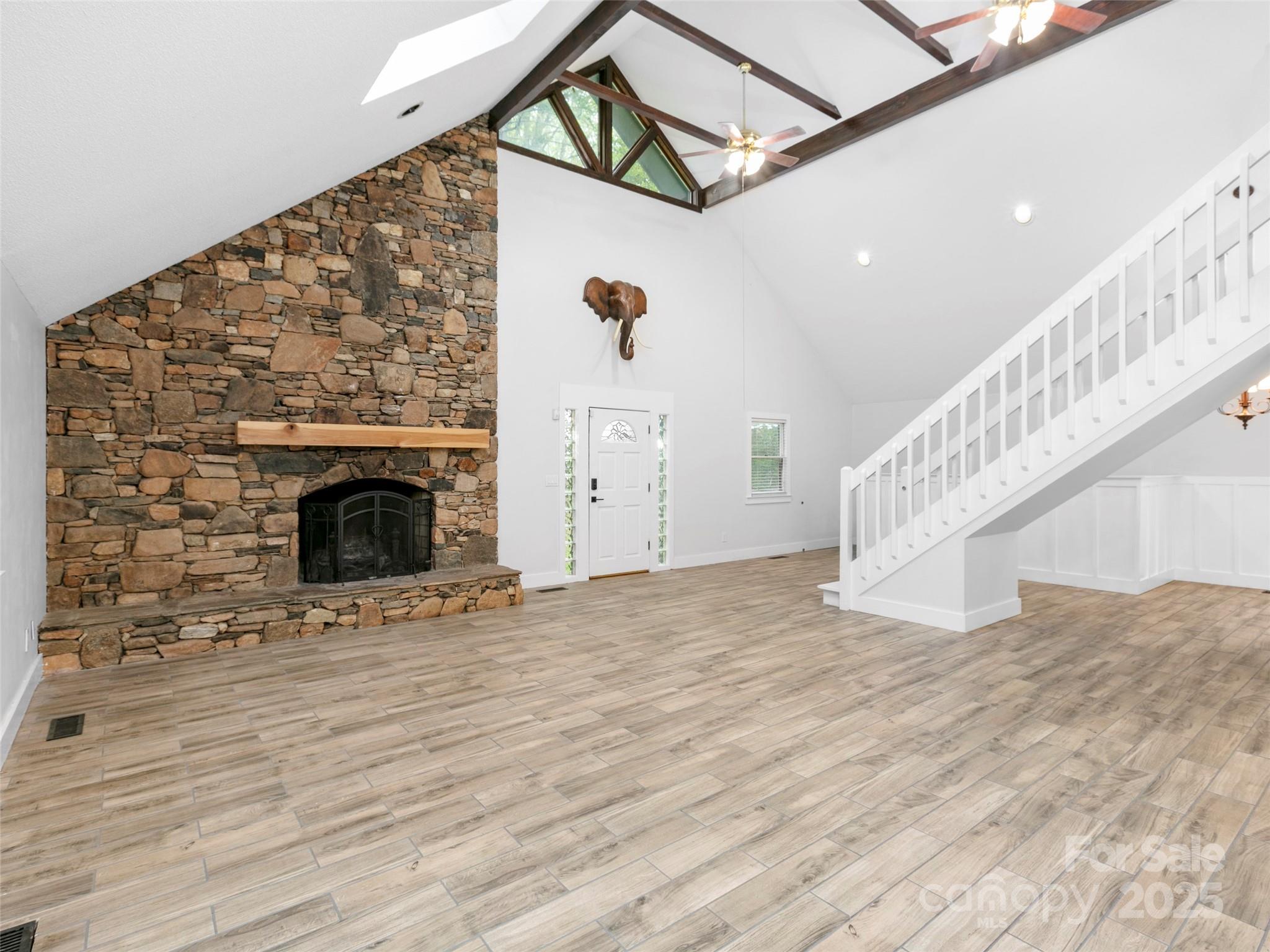 373 Vineyard Road Tryon, NC 28782 - Photo 3 of 46 a view of a livingroom with wooden floor and a fireplace