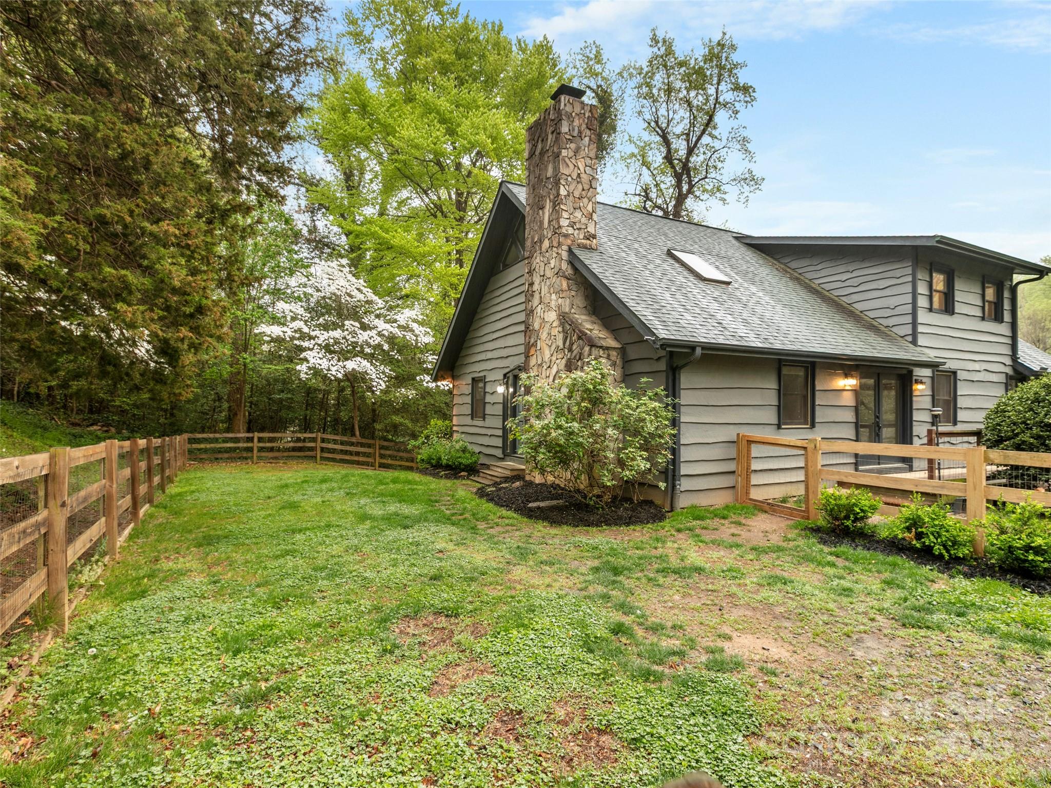 373 Vineyard Road Tryon, NC 28782 - Photo 33 of 46 a view of a house with a yard and sitting area