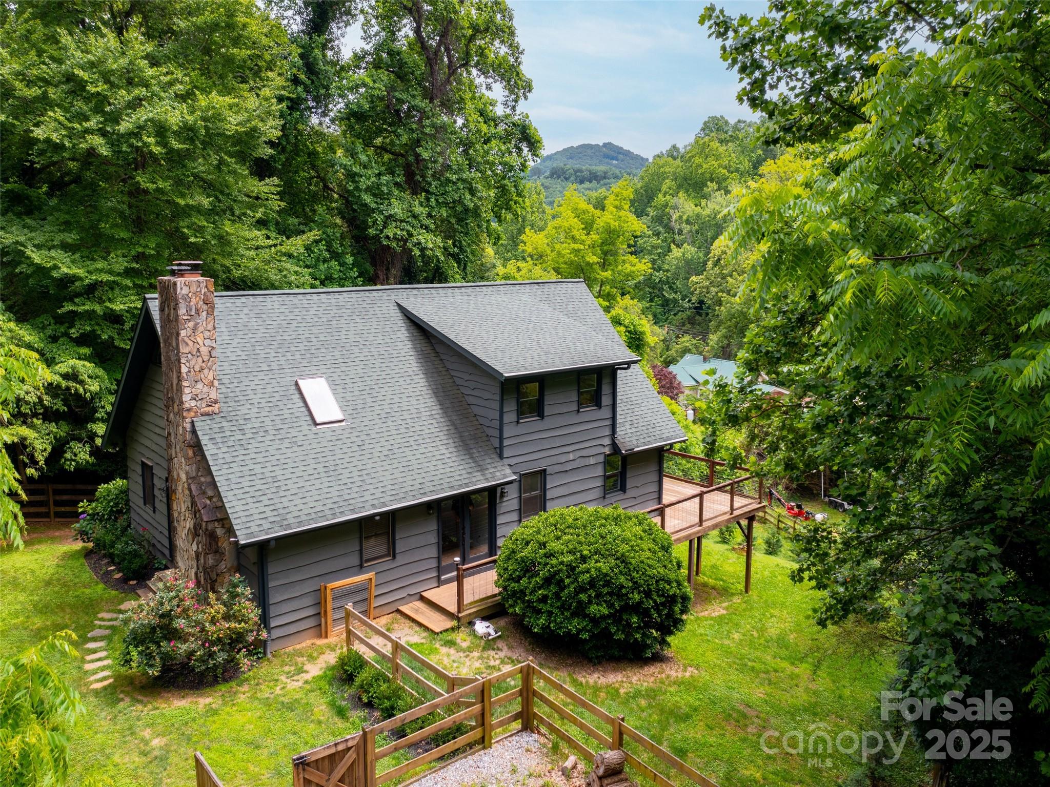373 Vineyard Road Tryon, NC 28782 - Photo 42 of 46 a view of an house with backyard space and garden