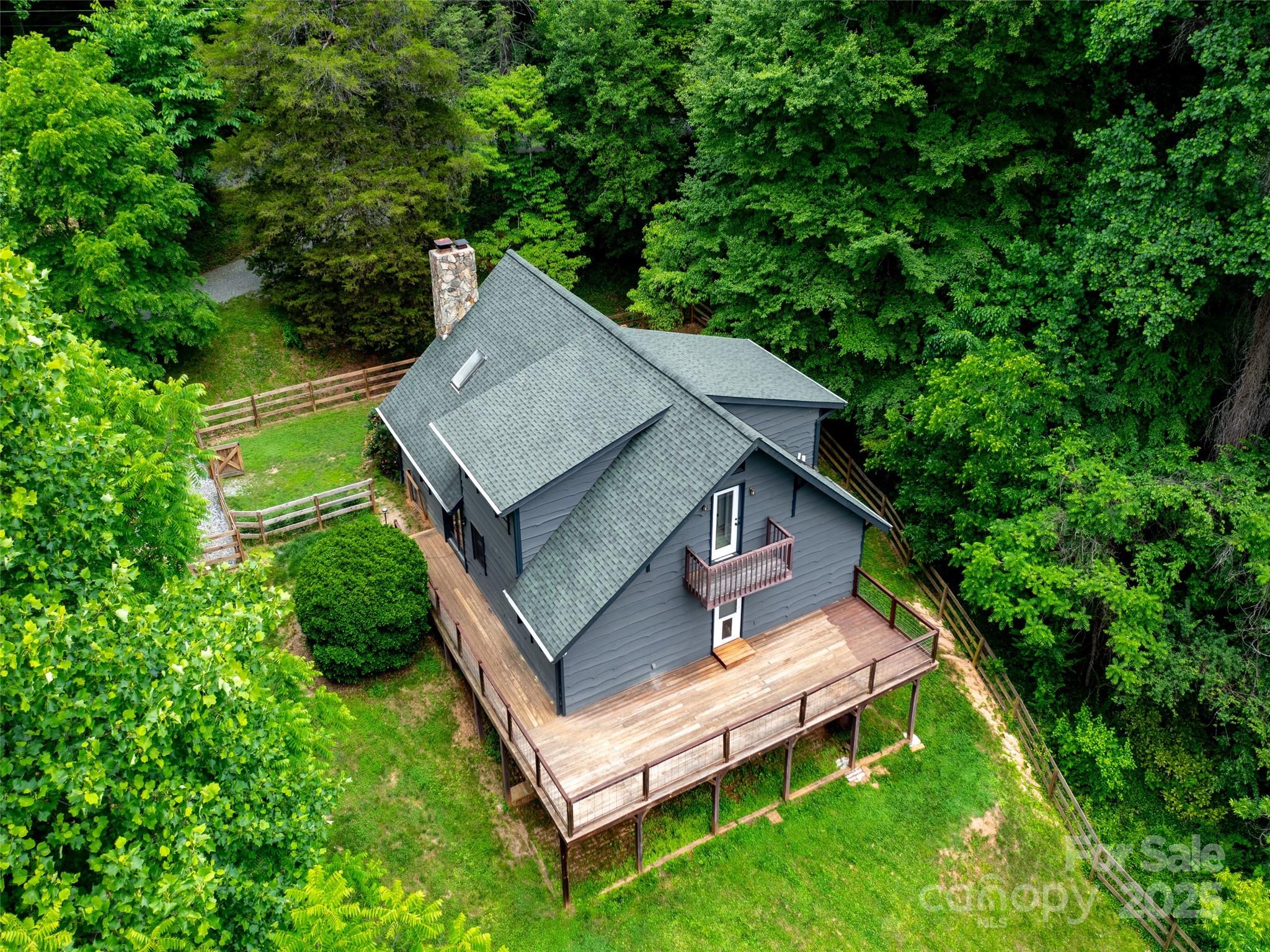 373 Vineyard Road Tryon, NC 28782 - Photo 44 of 46 an aerial view of a house with a yard table and chairs