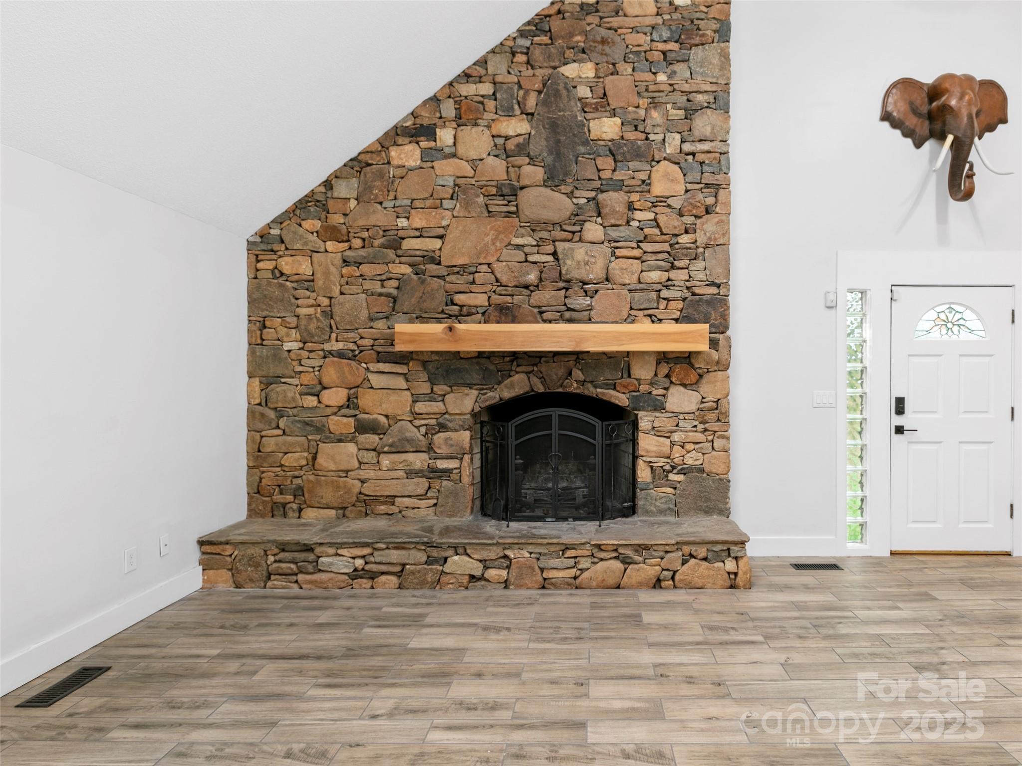 373 Vineyard Road Tryon, NC 28782 - Photo 5 of 46 a view of fireplace with wooden floor