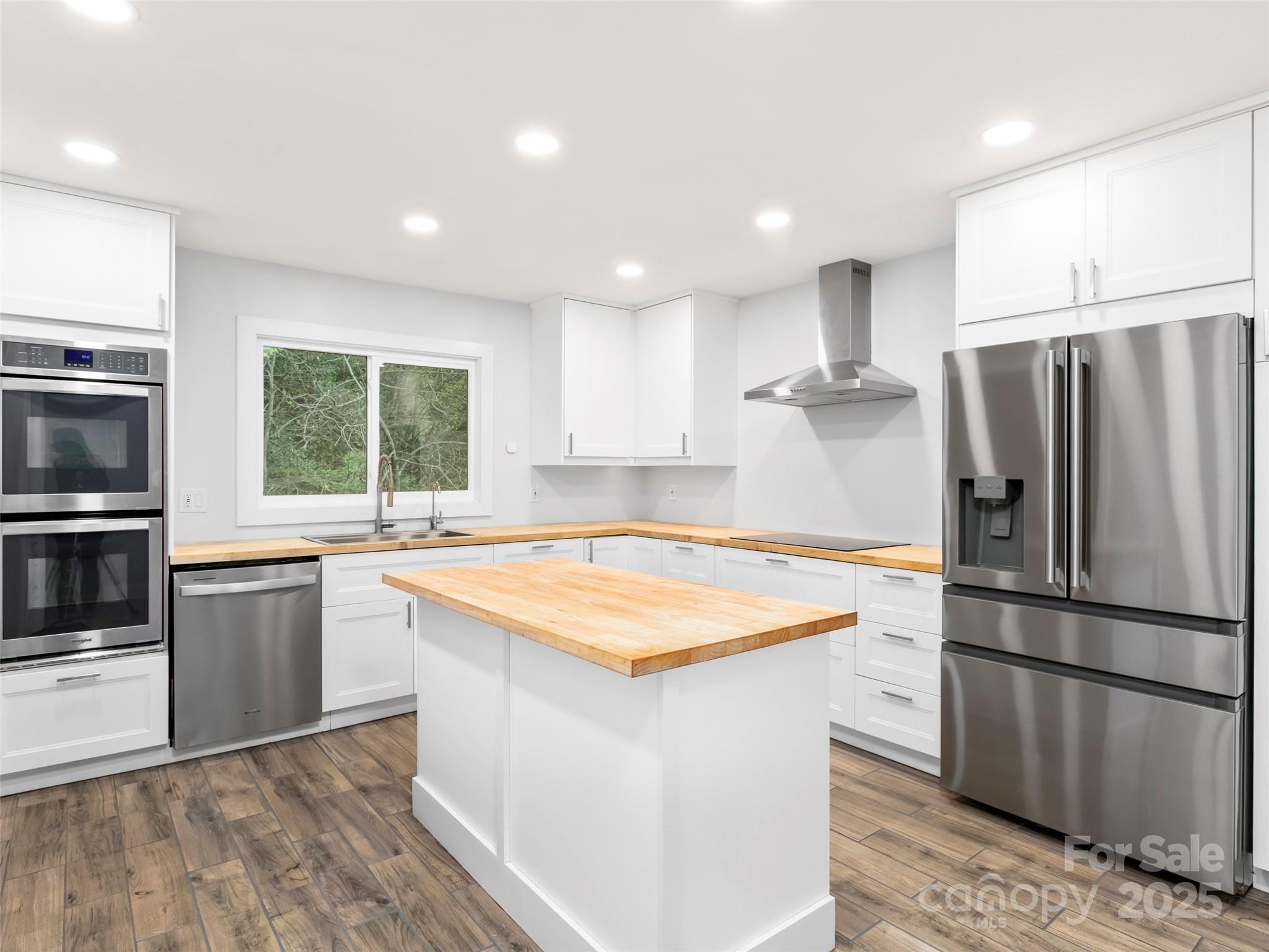 373 Vineyard Road Tryon, NC 28782 - Photo 7 of 46 a kitchen with stainless steel appliances granite countertop a refrigerator a sink a stove a microwave and island