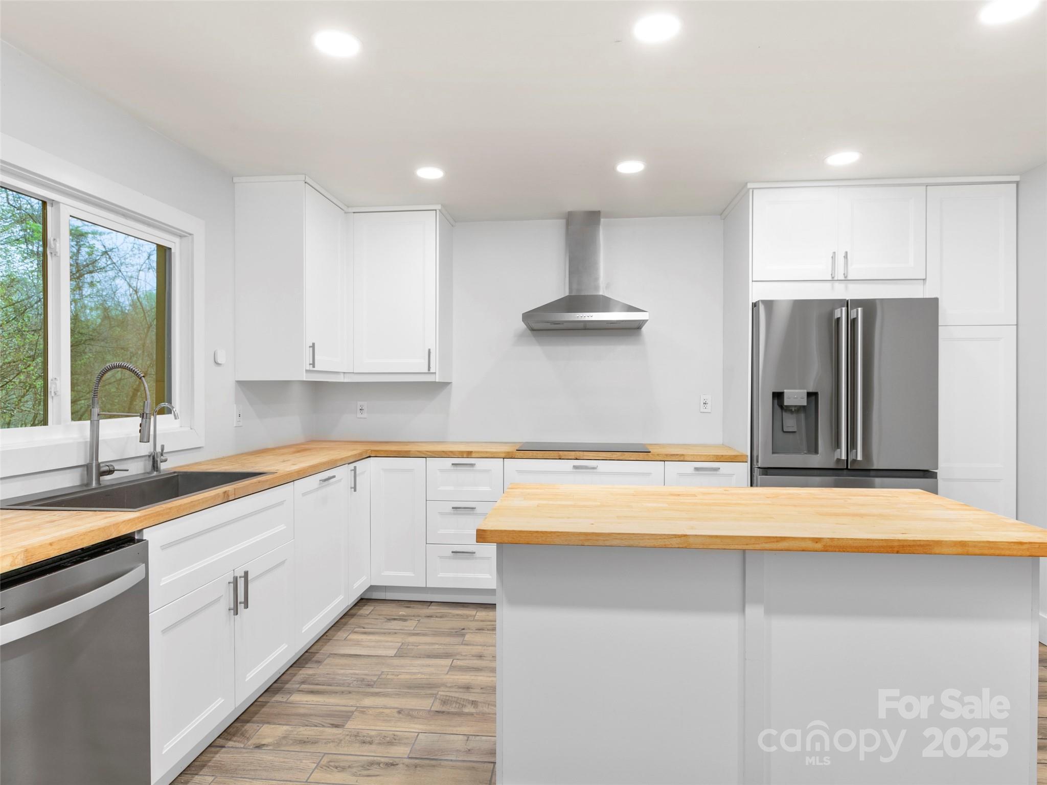 373 Vineyard Road Tryon, NC 28782 - Photo 8 of 46 a kitchen with stainless steel appliances granite countertop a sink and a refrigerator