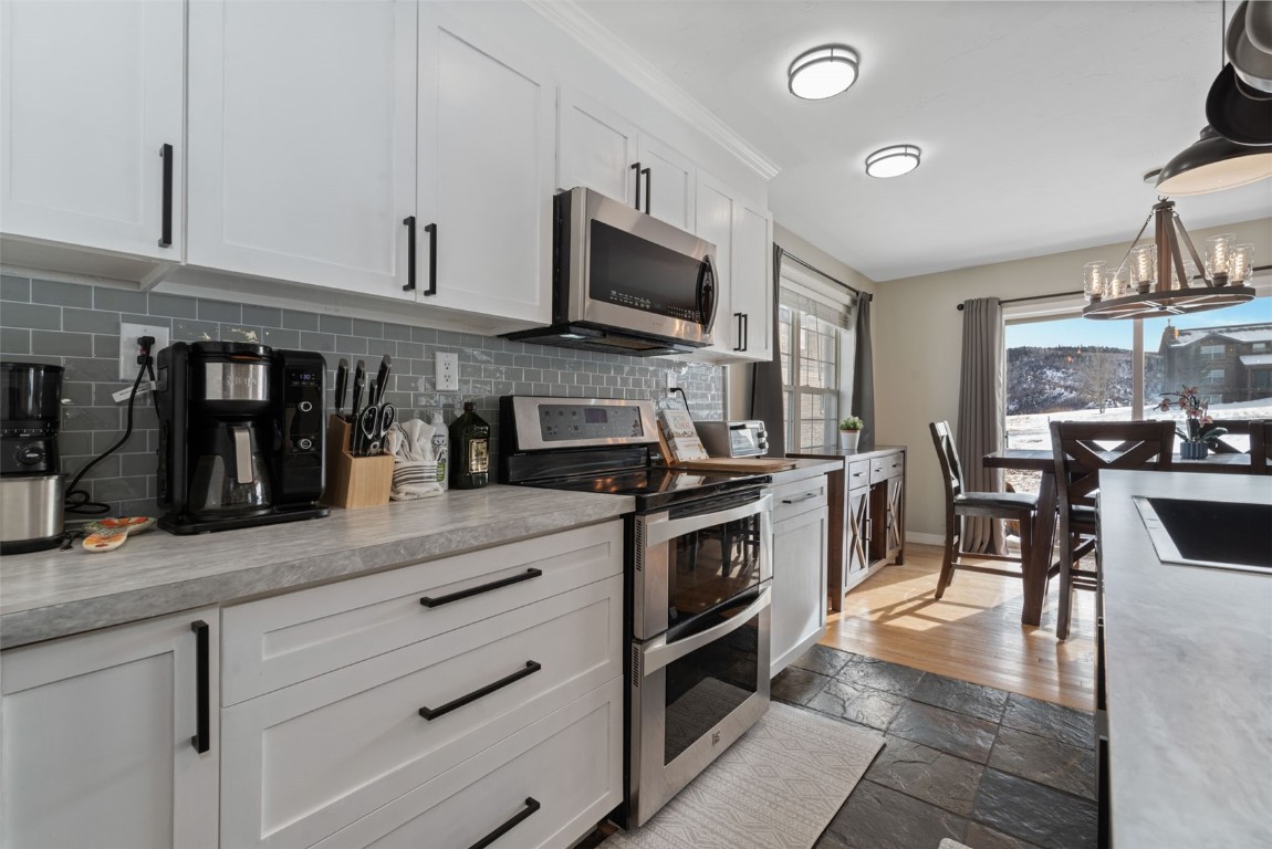 158 Oak Ridge Circle Oak Creek, CO 80467 - Photo 11 of 47 a kitchen with stainless steel appliances granite countertop a stove and a sink