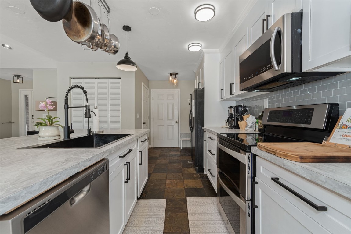 158 Oak Ridge Circle Oak Creek, CO 80467 - Photo 13 of 47 a kitchen with stainless steel appliances granite countertop a stove a sink and a microwave