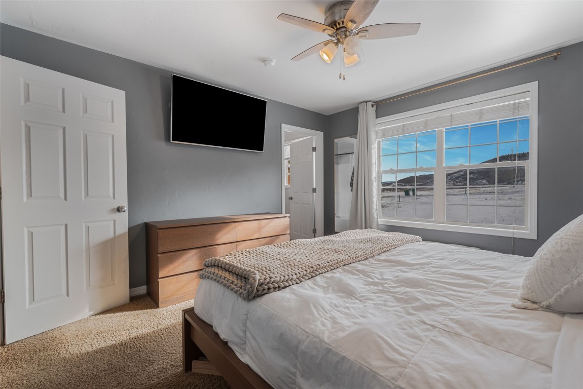 158 Oak Ridge Circle Oak Creek, CO 80467 - Photo 30 of 47 a bedroom with a bed and a flat screen tv