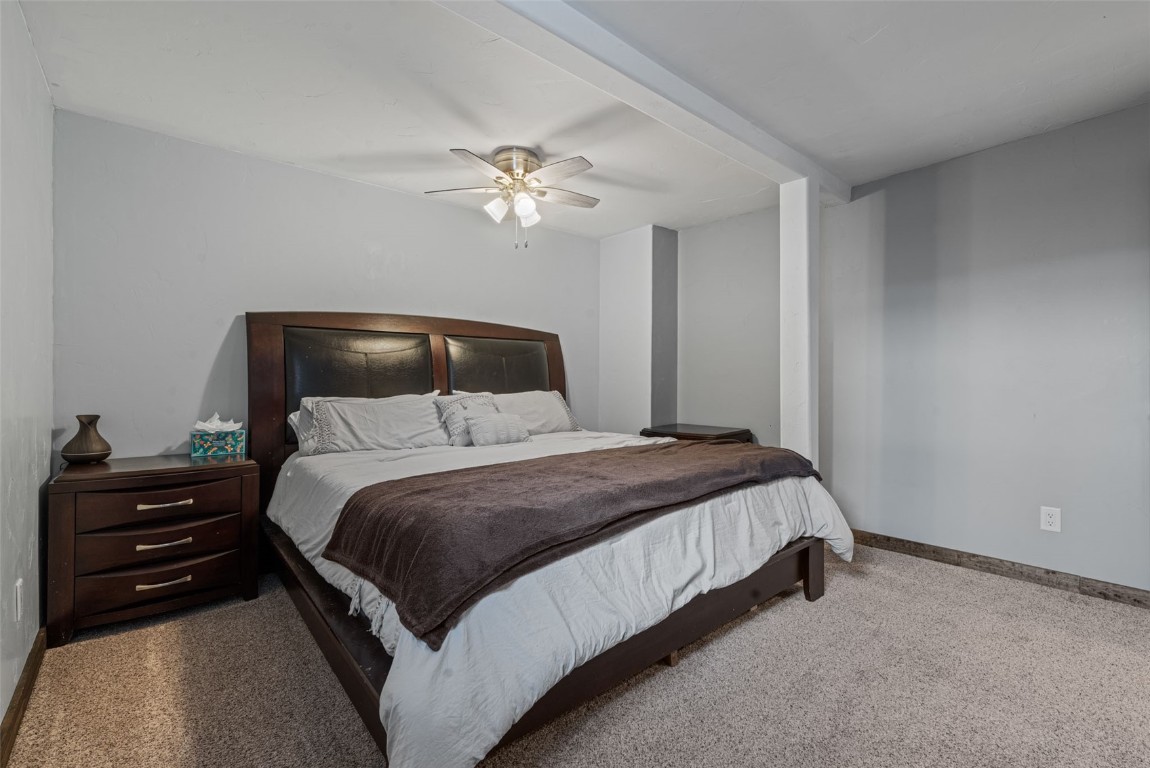 158 Oak Ridge Circle Oak Creek, CO 80467 - Photo 40 of 47 a bedroom with a bed and a chandelier