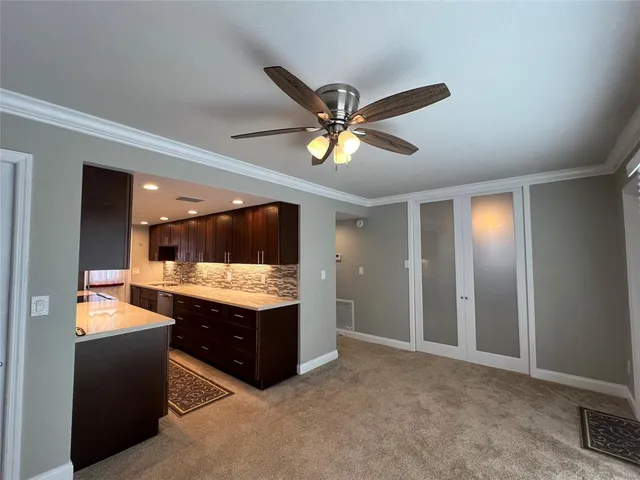 a view of kitchen with granite countertop a sink and a stove top oven