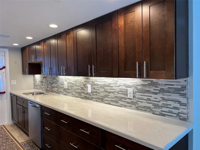 a kitchen with a sink and cabinets