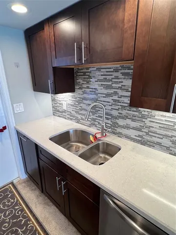 a kitchen with a sink and cabinets