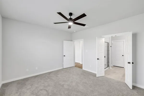 a view of an empty room with a ceiling fan