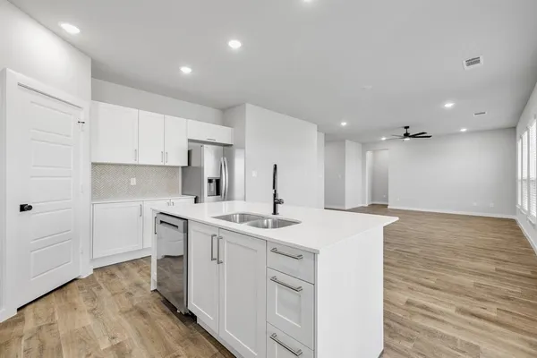 a kitchen with a sink stove and cabinets