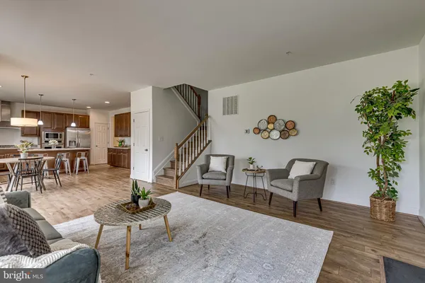 a living room with furniture and a potted plant
