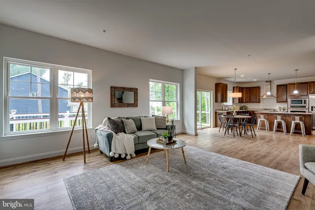 a living room with furniture and a table with kitchen view