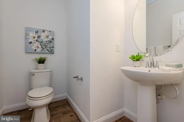 a bathroom with a sink mirror and toilet