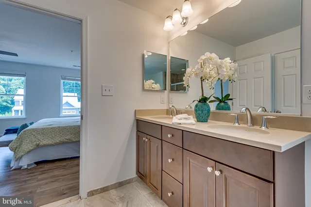 a en suite bathroom with double sink and a mirror