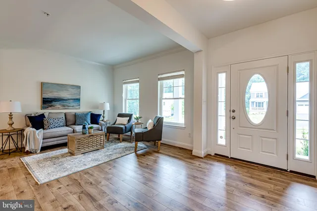 a living room with furniture window and wooden floor