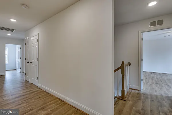 a view of a hallway with wooden floor