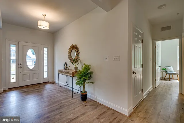 wooden floor in an empty room with a mirror
