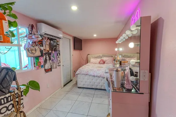 a bedroom with a large bed and a potted plant