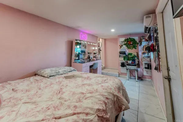 a bedroom with a bed and a couch