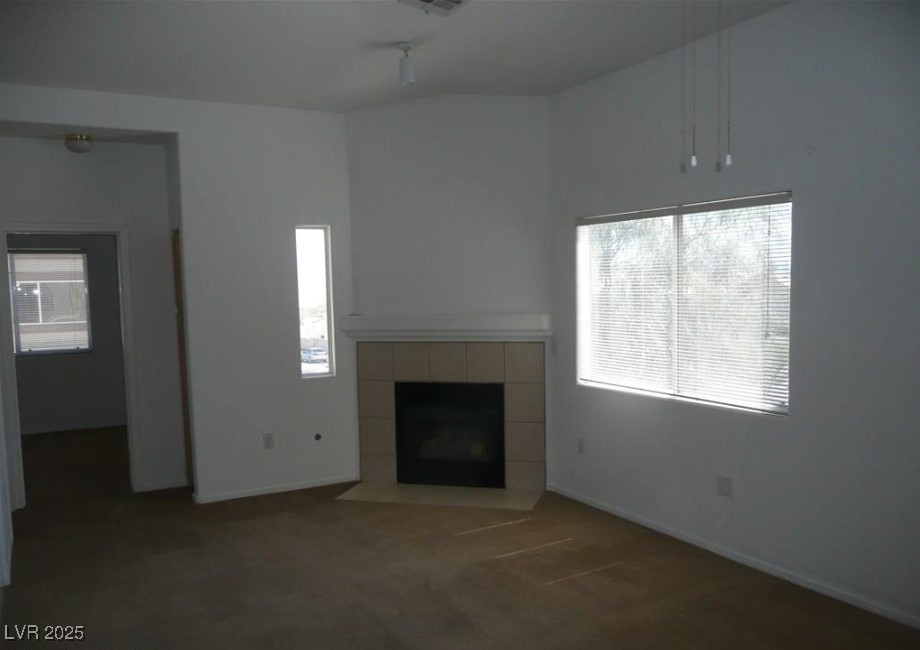 8725 West Flamingo Road, Unit 226 Las Vegas, NV 89147 - Photo 2 of 7 Unfurnished living room with a fireplace, carpet flooring, and plenty of natural light