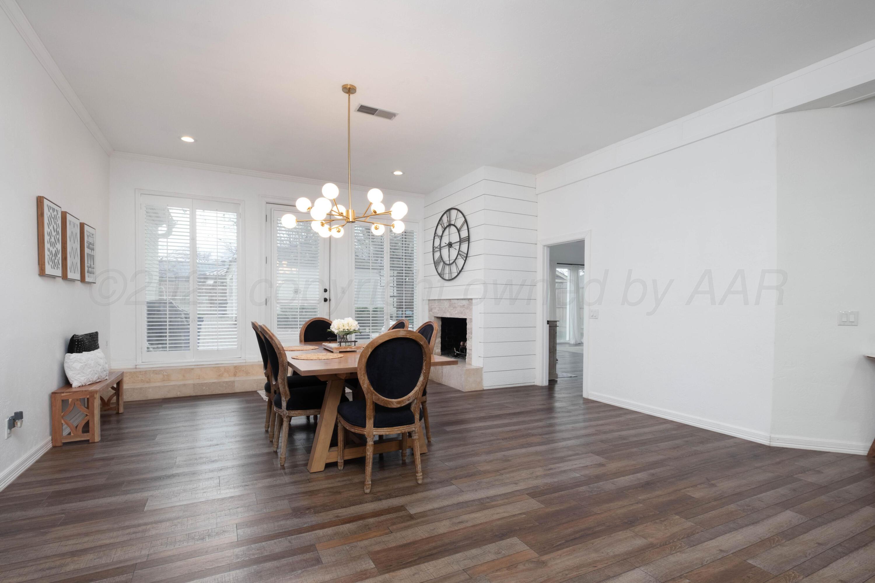 3207 Parker Street Amarillo, TX 79109 - Photo 26 of 73 a view of a dining room with furniture a chandelier and wooden floor