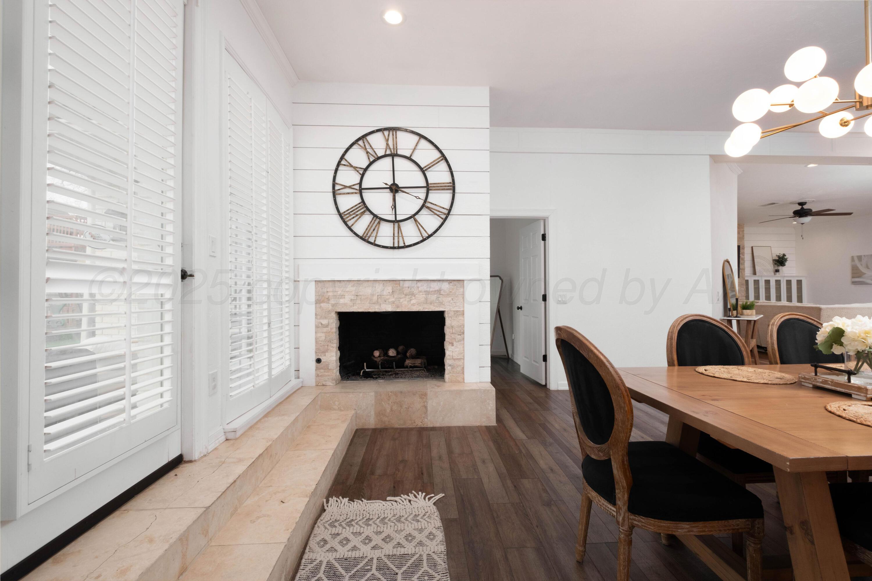 3207 Parker Street Amarillo, TX 79109 - Photo 27 of 73 a view of a dining room with furniture a fireplace and wooden floor