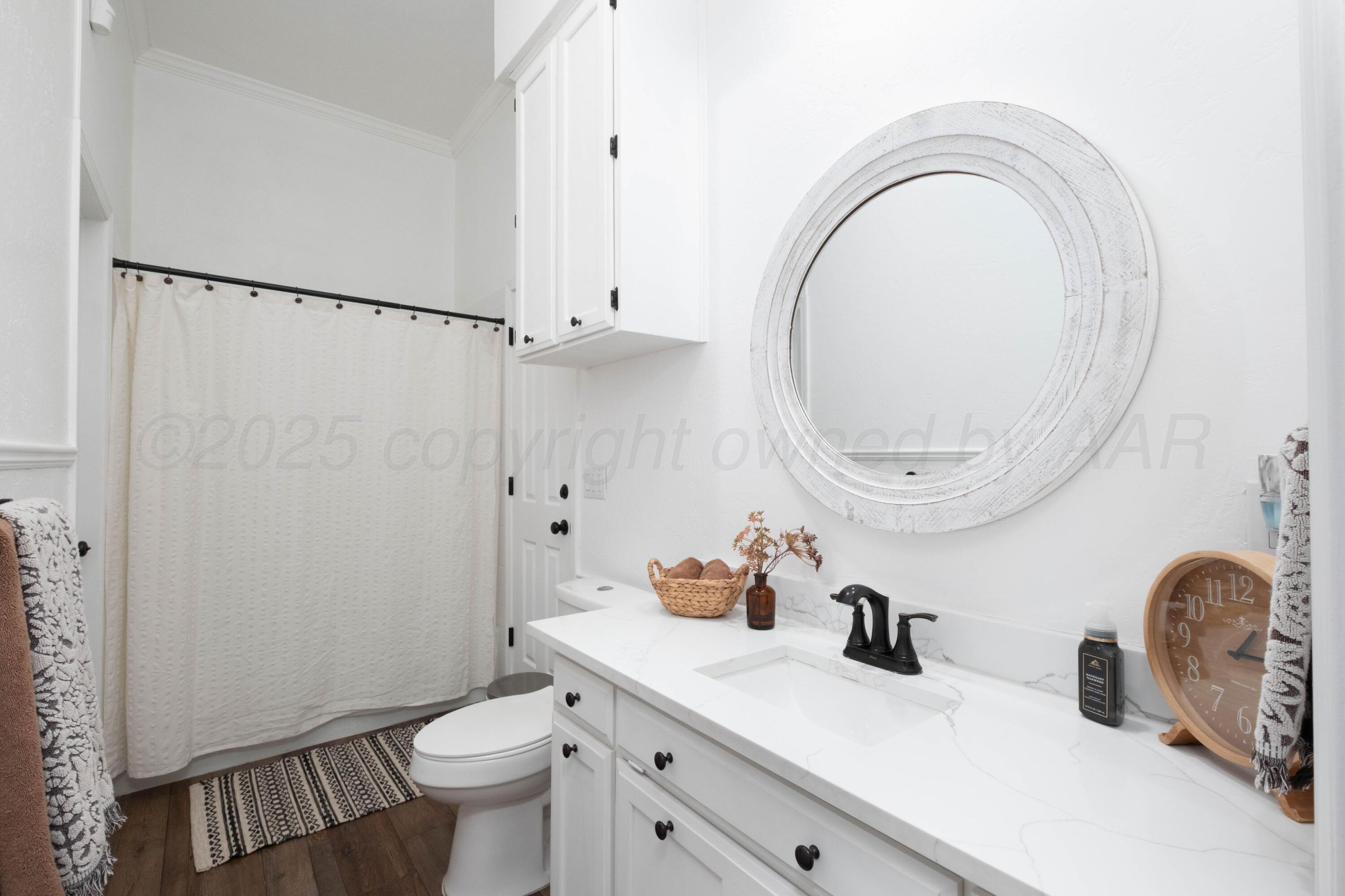 3207 Parker Street Amarillo, TX 79109 - Photo 48 of 73 a bathroom with a sink a toilet and a mirror