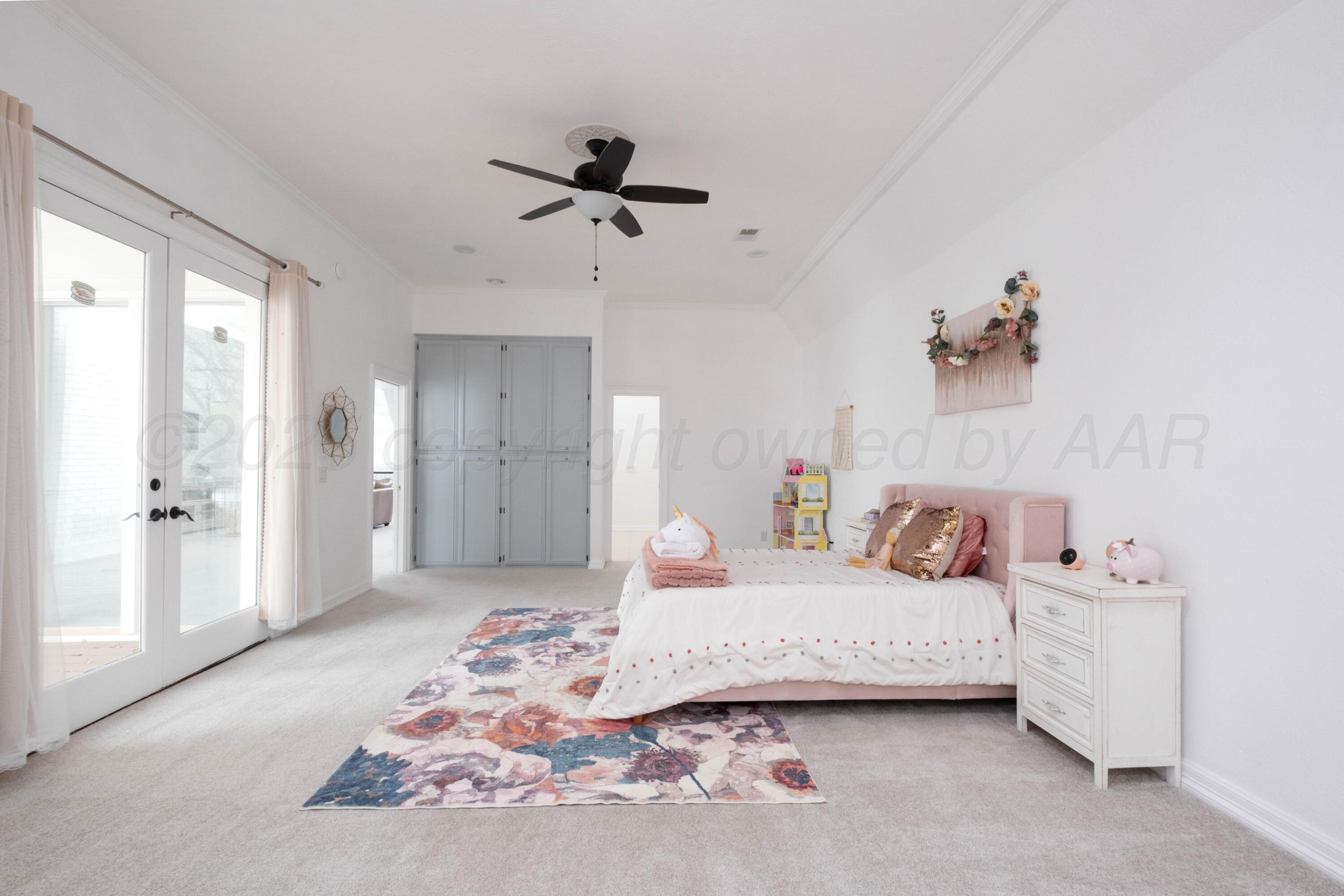3207 Parker Street Amarillo, TX 79109 - Photo 54 of 73 a bedroom with a bed and a chandelier