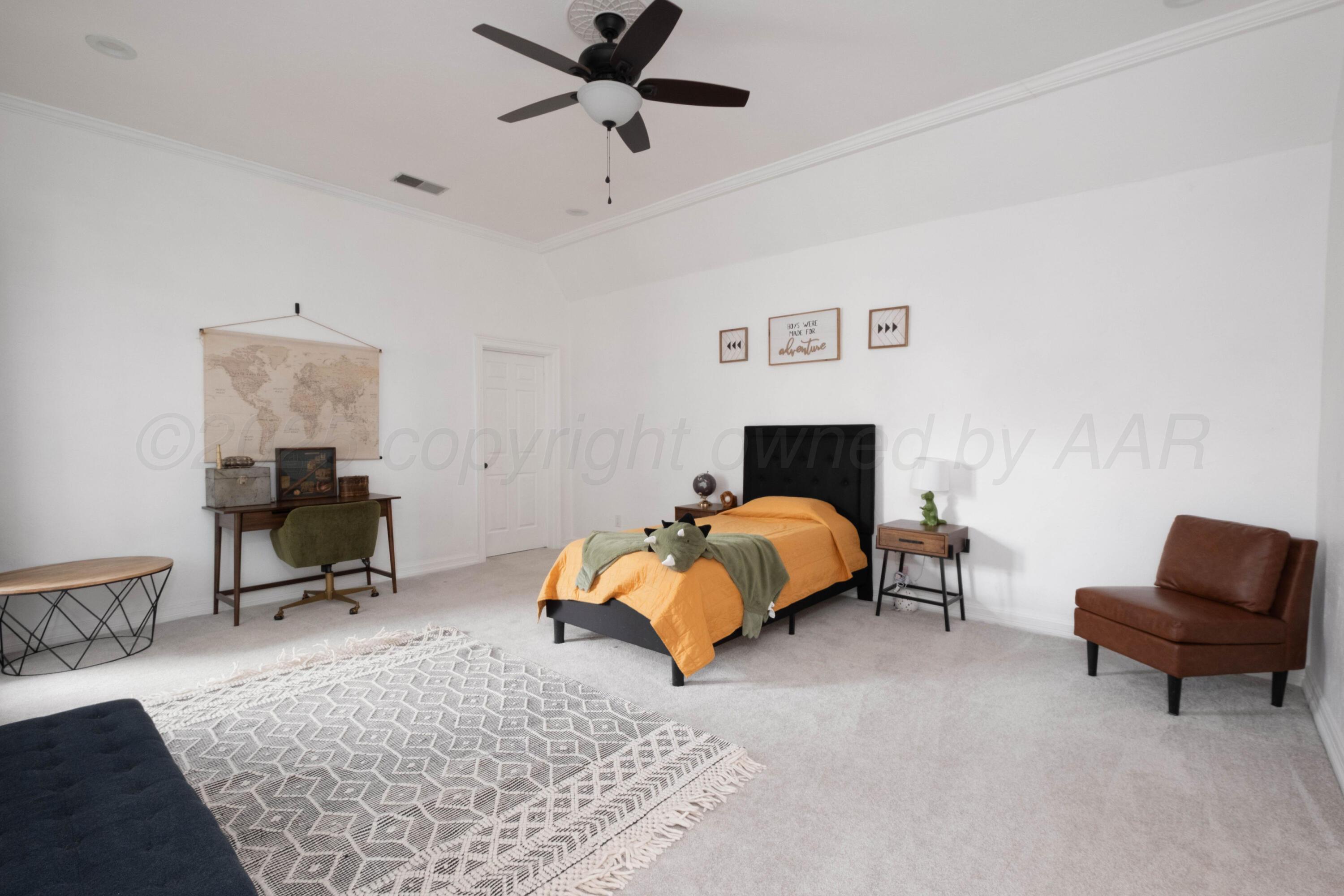 3207 Parker Street Amarillo, TX 79109 - Photo 58 of 73 a bedroom with a bed a chair and potted plant on the dresser