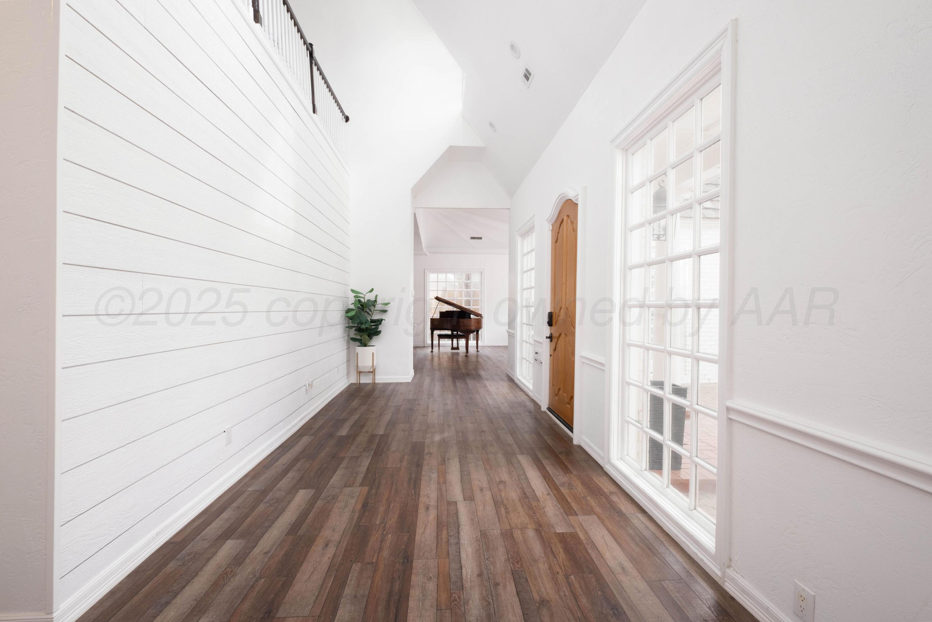 3207 Parker Street Amarillo, TX 79109 - Photo 10 of 73 a view of a hallway with wooden floor and staircase