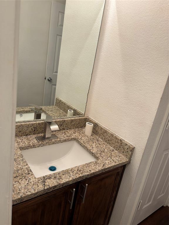 6546 Portside Ridge Lane Dallas, TX 75249 - Photo 13 of 35 Bathroom with a textured wall and vanity