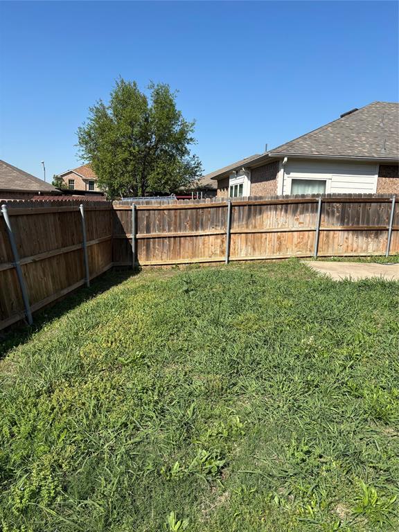 6546 Portside Ridge Lane Dallas, TX 75249 - Photo 18 of 35 View of yard with a fenced backyard