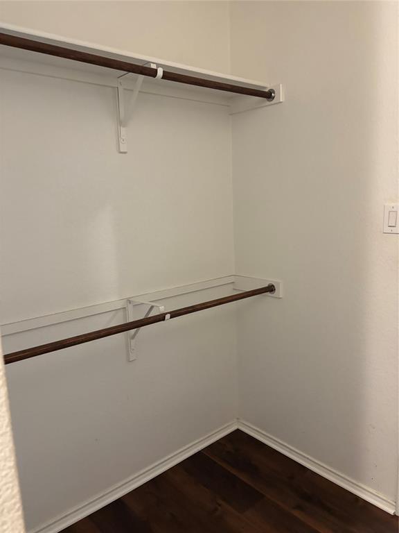 6546 Portside Ridge Lane Dallas, TX 75249 - Photo 23 of 35 Walk in closet with dark wood-style floors