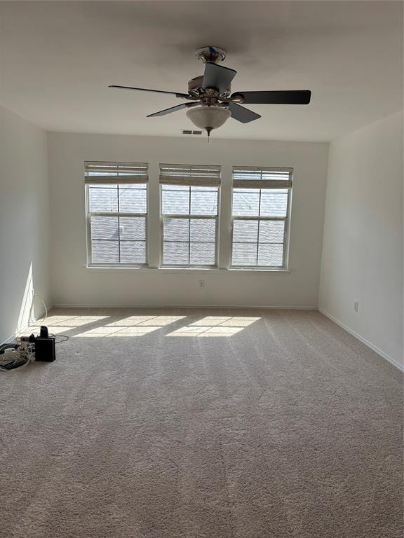 6546 Portside Ridge Lane Dallas, TX 75249 - Photo 4 of 35 Unfurnished room featuring carpet, visible vents, baseboards, and a ceiling fan