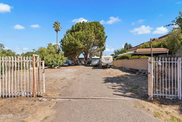 a view of street with wooden fence