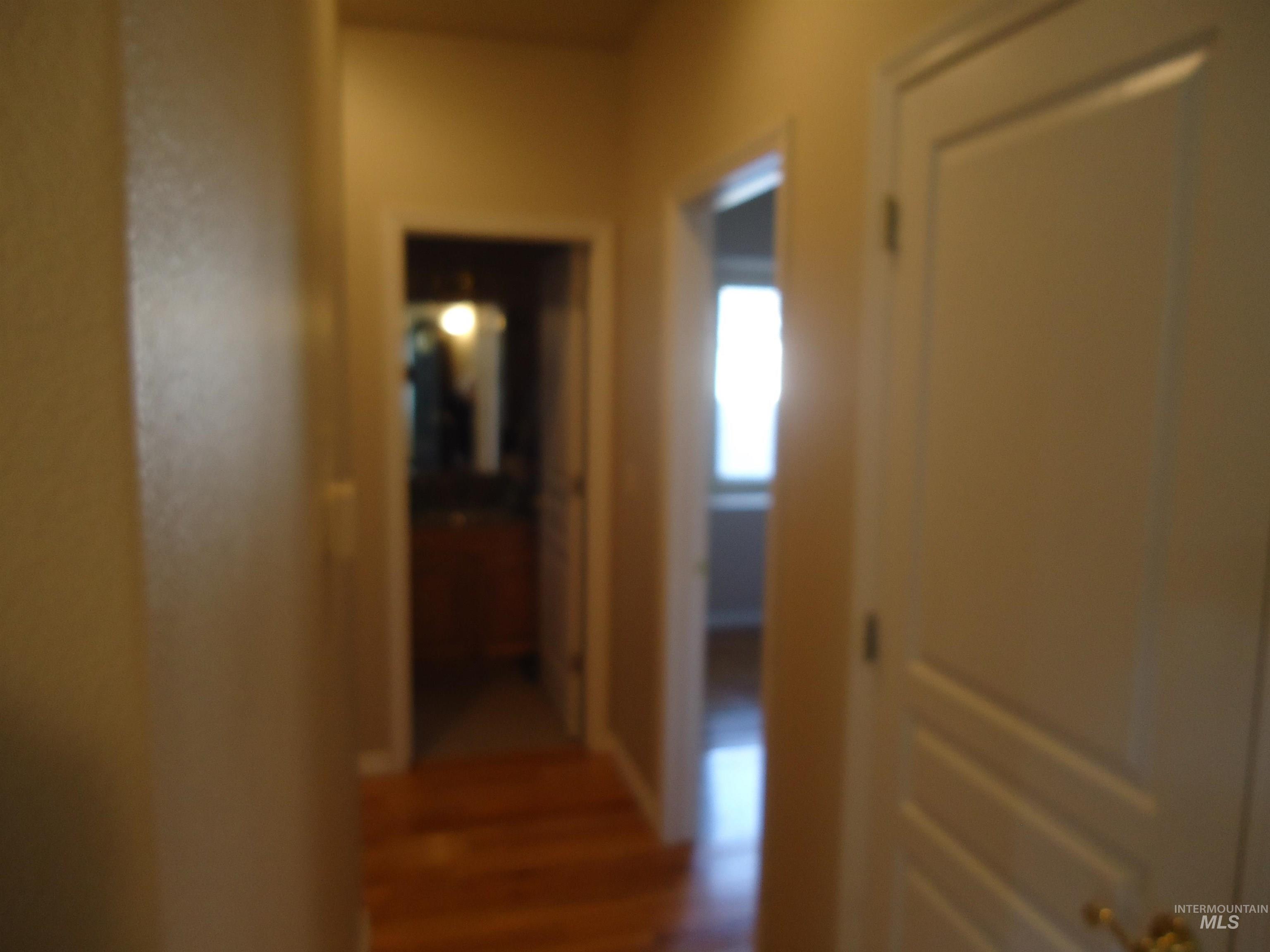 2734 North Turnberry Way Meridian, ID 83646 - Photo 14 of 18 Corridor featuring dark wood-type flooring
