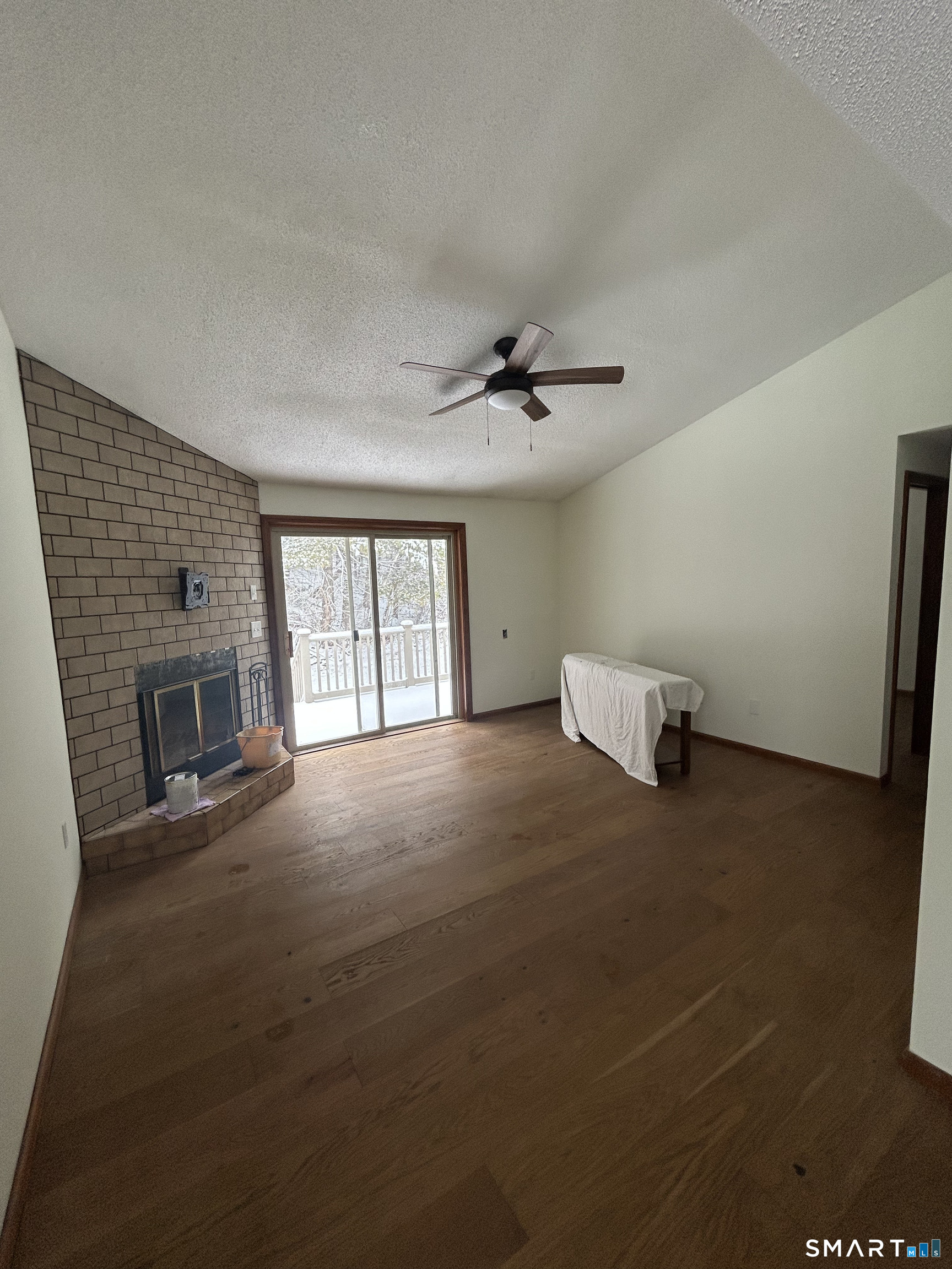 33 Baxter Road, Unit 4A Willington, CT 06279 - Photo 3 of 9 a view of an empty room with a fireplace and a window