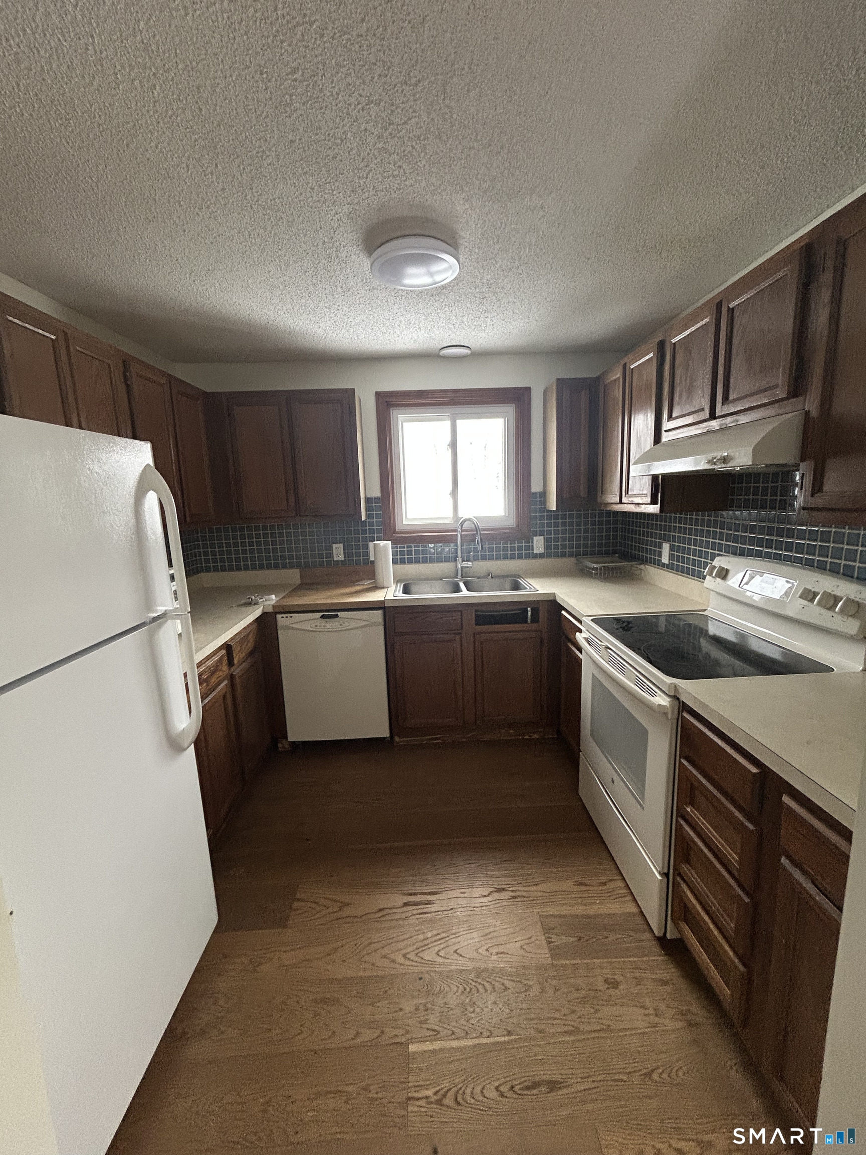 33 Baxter Road, Unit 4A Willington, CT 06279 - Photo 5 of 9 a kitchen with a sink a refrigerator a window and cabinets