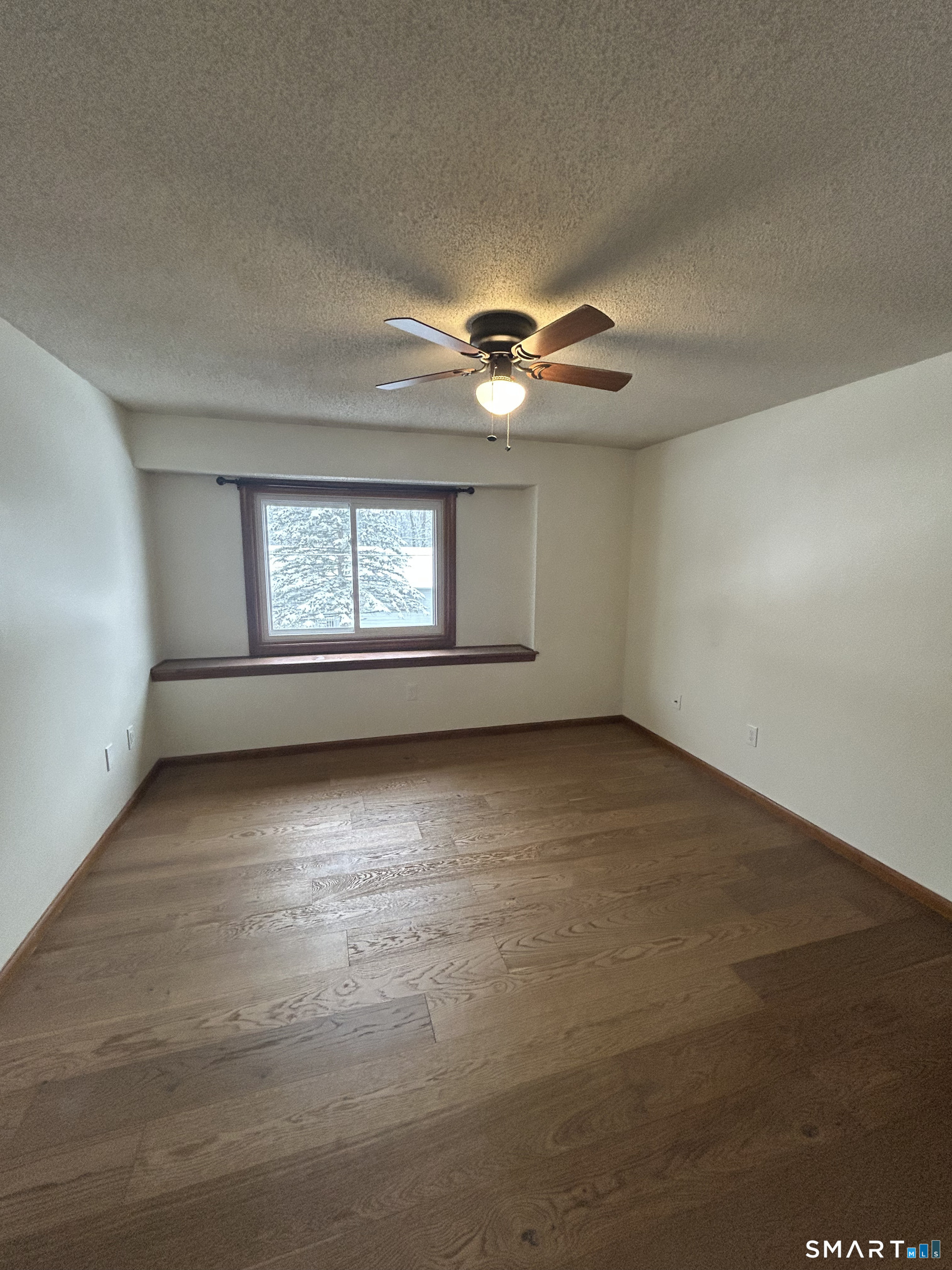 33 Baxter Road, Unit 4A Willington, CT 06279 - Photo 8 of 9 an empty room with chandelier fan and windows