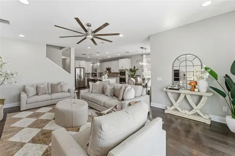 a living room with furniture a rug and white walls