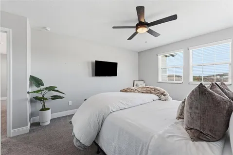 a spacious bedroom with a bed and a window