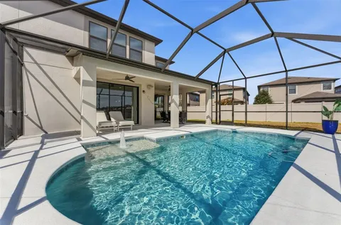 a view of a backyard with floor to ceiling window and wooden fence
