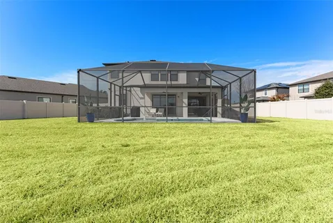 a large house with swimming pool in front of it