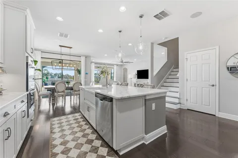 a kitchen with counter top space and wooden floor