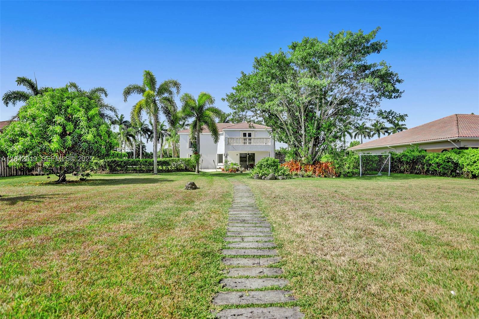 721 Ranch Road Weston, FL 33326 - Photo 18 of 38 a front view of a house with garden