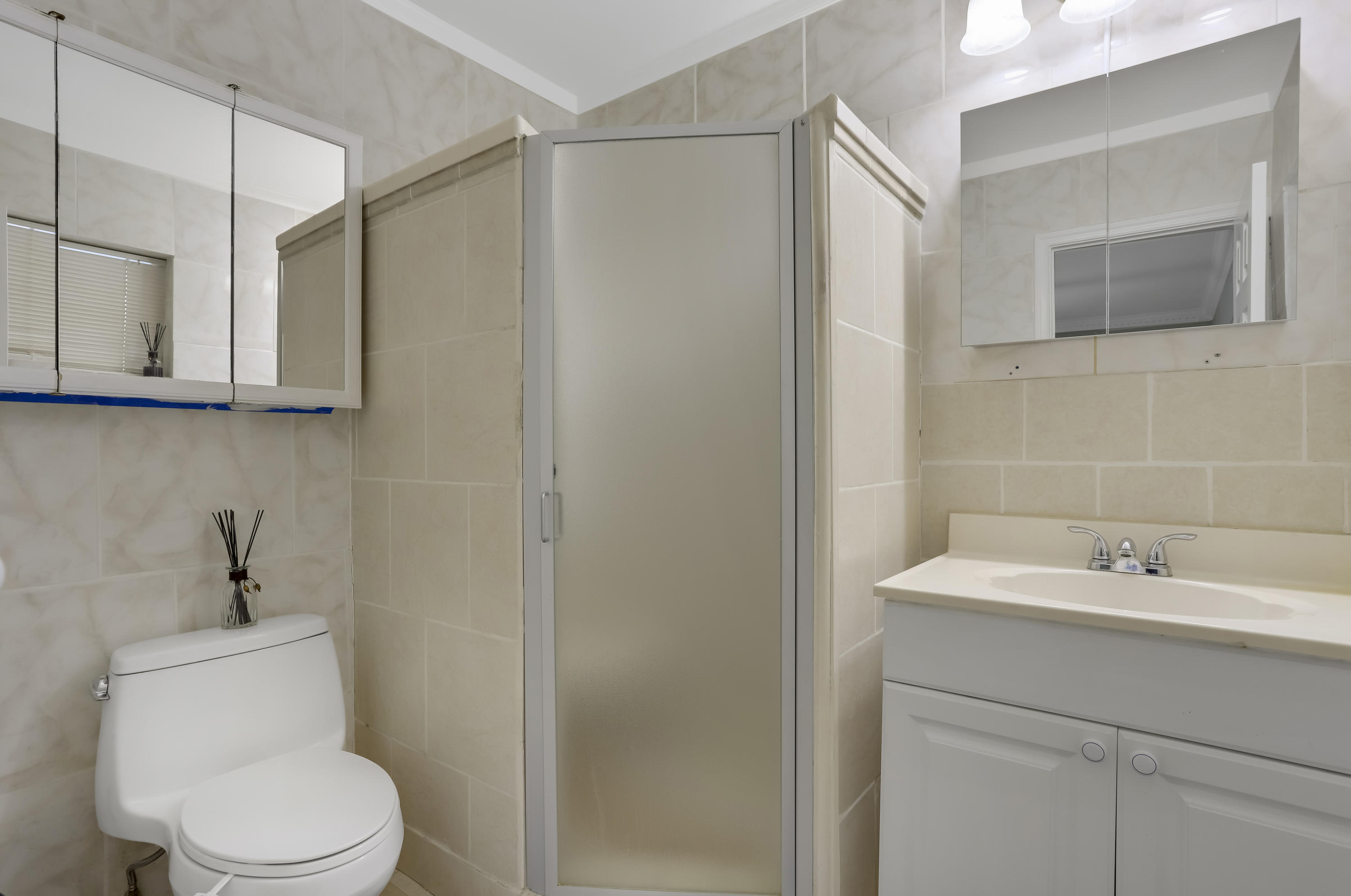 1346 Northwest 4th Street Boca Raton, FL 33486 - Photo 17 of 33 a bathroom with a sink a toilet and shower