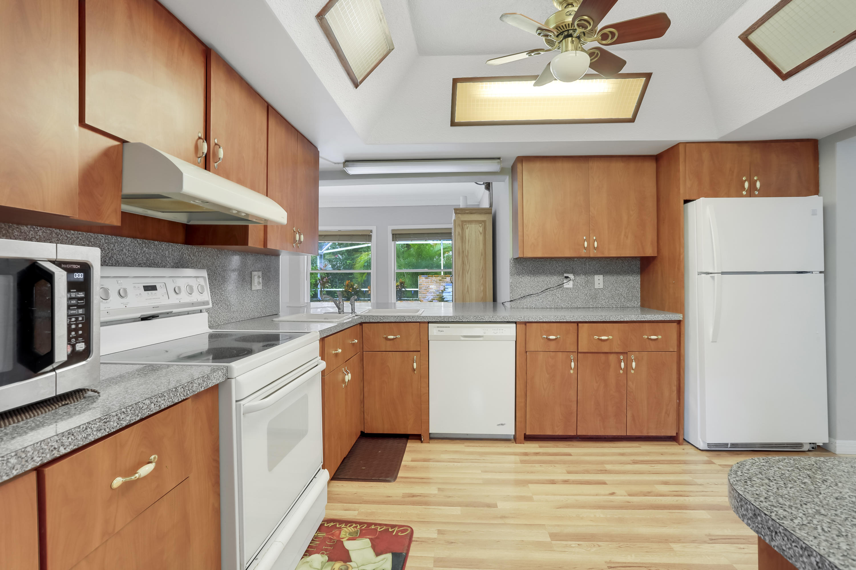 1346 Northwest 4th Street Boca Raton, FL 33486 - Photo 19 of 33 a kitchen with stainless steel appliances granite countertop a refrigerator sink and cabinets